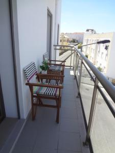 een balkon met 2 stoelen en een tafel op een gebouw bij Pôr do Sol II in Nazaré