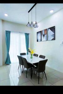a dining room with a table and chairs at GUESTHOUSE #2 Semi Bungalow House in Kuah