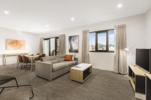 a living room filled with furniture and a large window at Quest Nowra in Nowra