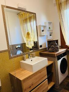 a bathroom with a sink and a washing machine at Giramondo in Senigallia