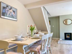 a dining room with a table and chairs at The Granary in Rowde