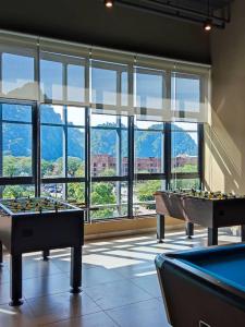 a room with two pool tables in front of a large window at Hotspring 2 Room Premium 1510 Suite Sunway Onsen Theme Park View, 5pax in Ipoh