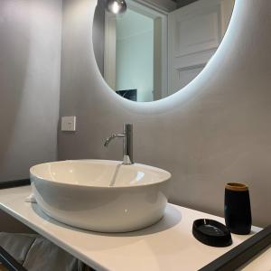 a bathroom with a white sink and a mirror at Donna Caterina in Monopoli