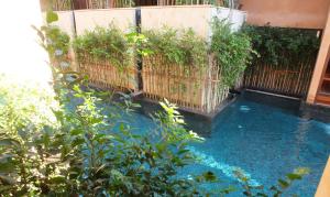 a backyard pool with a fence and blue water at Avatar Railay in Railay Beach