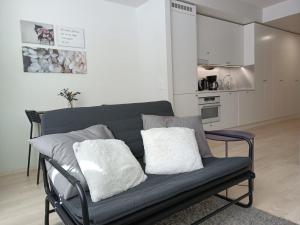 a couch with two pillows on it in a kitchen at Transit Apartment HEL Airport in Vantaa