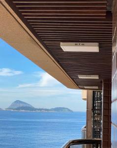 a view of the ocean from the balcony of a building at Apto Avenida Vieira Souto in Rio de Janeiro