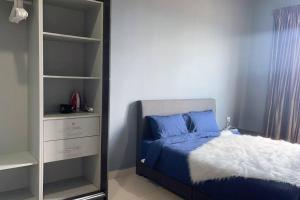 a bedroom with a bed and a book shelf at Modern Dpulze Soho fit 4pax,Netflix provided in Cyberjaya