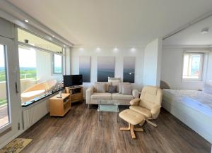 a living room with a couch and a bed at Panoramic App B10-7 in Sierksdorf