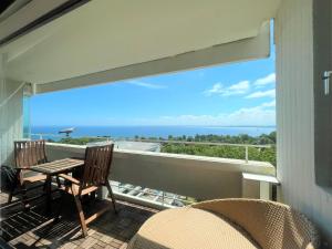 a balcony with a table and chairs and a view of the ocean at Panoramic App B10-7 in Sierksdorf