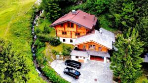 una vista aérea de una casa grande con dos coches aparcados en MOUNTAINRANGER - Lodge - ski in & ski out, en Obertauern