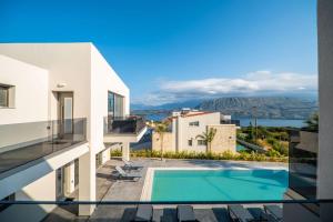 a view from the balcony of a house with a swimming pool at Jarko Luxury Houses in Argoulidhés