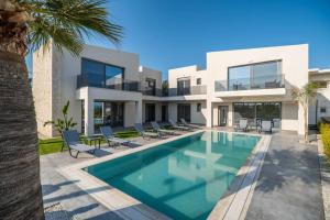 a villa with a swimming pool in front of it at Jarko Luxury Houses in Argoulidhés +37 photos