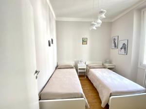 una camera ospedaliera con tre letti e una finestra di Comoluxhouse- Intero appartamento a Como