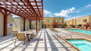 a patio with a table and chairs next to a pool at Entrada at Moab #668 in Moab