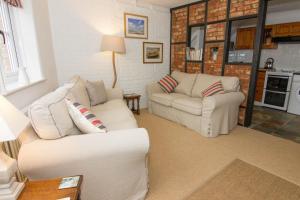 a living room with two white couches and a table at Home Lea in Docking