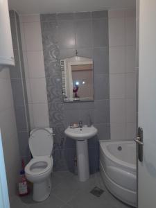 un bagno con un water, un lavandino e una vasca di For you apartman a Niš