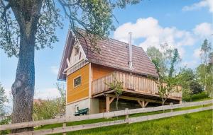 a house with a wrap around porch and a fence at Amazing Home In Preitenegg With Wifi And 1 Bedrooms in Unterauerling
