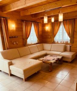 a living room with a couch and a table at CHALET GAMSBOCK Koralpe in Elsenbrunn