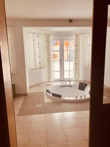 a bath tub in a room with a large window at CHALET GAMSBOCK Koralpe in Elsenbrunn