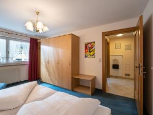 a bedroom with a bed and a door to a bathroom at Haus Eberharter in Mayrhofen +6 photos