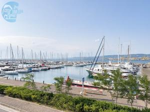 a marina with lots of boats in the water at San Rocco Sweet Apartments in Muggia