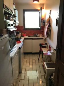 a small kitchen with a sink and a window at Charming Apartment ideal for families in Megève +2 photos