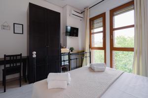 a bedroom with a bed with two white towels at B&B Elegance in Bologna