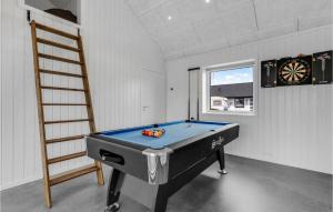 a pool table in a room with a ladder at Beautiful Home In Nexø With Kitchen in Neksø