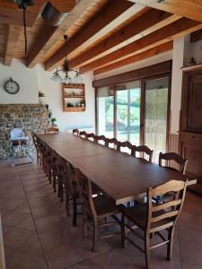 a large dining room with a large wooden table and chairs at El torreon de la Bruna in Artieda