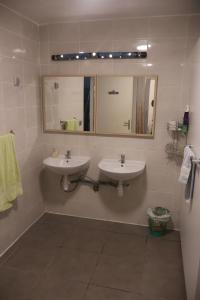 a bathroom with two sinks and a mirror at Solfé Backpacker in Luz-Saint-Sauveur