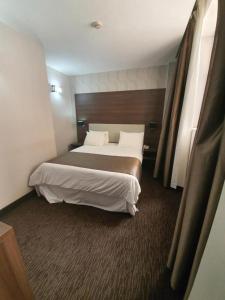 a bedroom with a large bed in a hotel room at Al Khaima City Center in Nouakchott