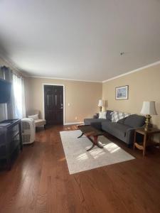 a living room with a couch and a table at Williston Village Inn in Burlington +25 photos