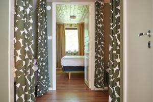 a hallway with black and white curtains and a bedroom at Tomatlyckan 1 in Vallåkra