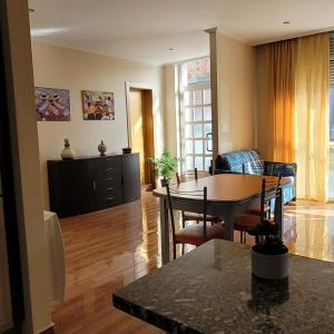 a kitchen and living room with a table and chairs at Casa Maside Orense in Maside
