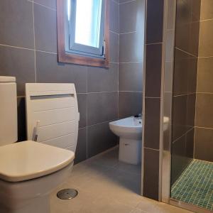 a bathroom with a toilet and a sink at Casa Maside Orense in Maside +14 photos