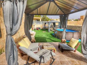 a gazebo with two chairs and a table at Heaven In The Desert in Mitzpe Ramon