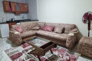 a living room with a couch and a table at ستوديو محطة الرمل على البحر Stodeo by the Sea in Alexandria