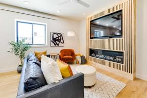 a living room with a couch and a large tv at The Lofts on 89 Condo - 5 Miles to Salt River! in Afton