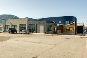 a building with a car parked in a parking lot at The Lofts on 89 Condo Near Bridger Natl Forest! in Afton