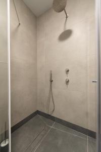 a bathroom with a shower with a shower head at PORT CITY HAIFA - Flea Market Luxury in Haifa