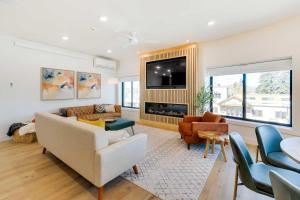 a living room with a couch and a tv at The Lofts on 89 Condo in Heart of Downtown Afton! in Afton