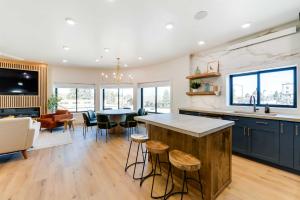 a kitchen and living room with a table and chairs at The Lofts on 89 Condo in Heart of Downtown Afton! in Afton