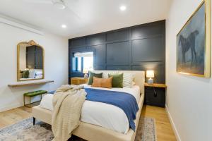 a bedroom with a large bed and a chair at The Lofts on 89 Condo in Heart of Downtown Afton! in Afton