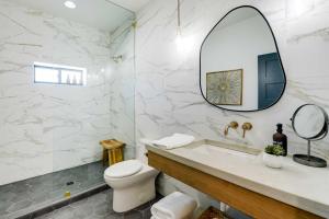 a bathroom with a toilet and a sink and a mirror at The Lofts on 89 Condo in Heart of Downtown Afton! in Afton +18 photos