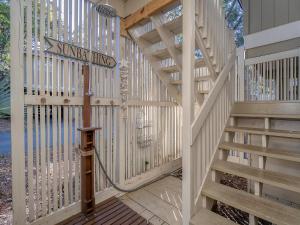 a wooden staircase in a house with a street sign at 1129 Summerwind Cottage in Seabrook Island