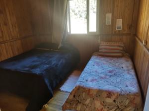 En eller flere senge i et værelse på Casas de temporada Serra dos Bitus