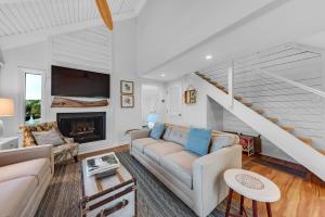 a living room with a couch and a fireplace at 903 Sealoft Villa in Seabrook Island