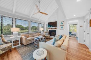 a living room with a couch and a fireplace at 903 Sealoft Villa in Seabrook Island