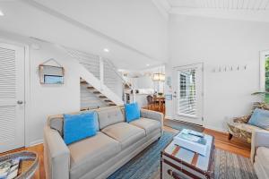 a living room with a couch and a staircase at 903 Sealoft Villa in Seabrook Island