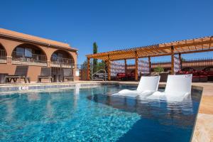 a swimming pool with white chairs in a building at GreenTree Inn Sedona in Sedona